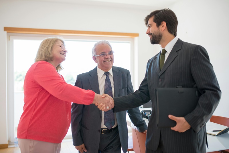 three people shaking hands